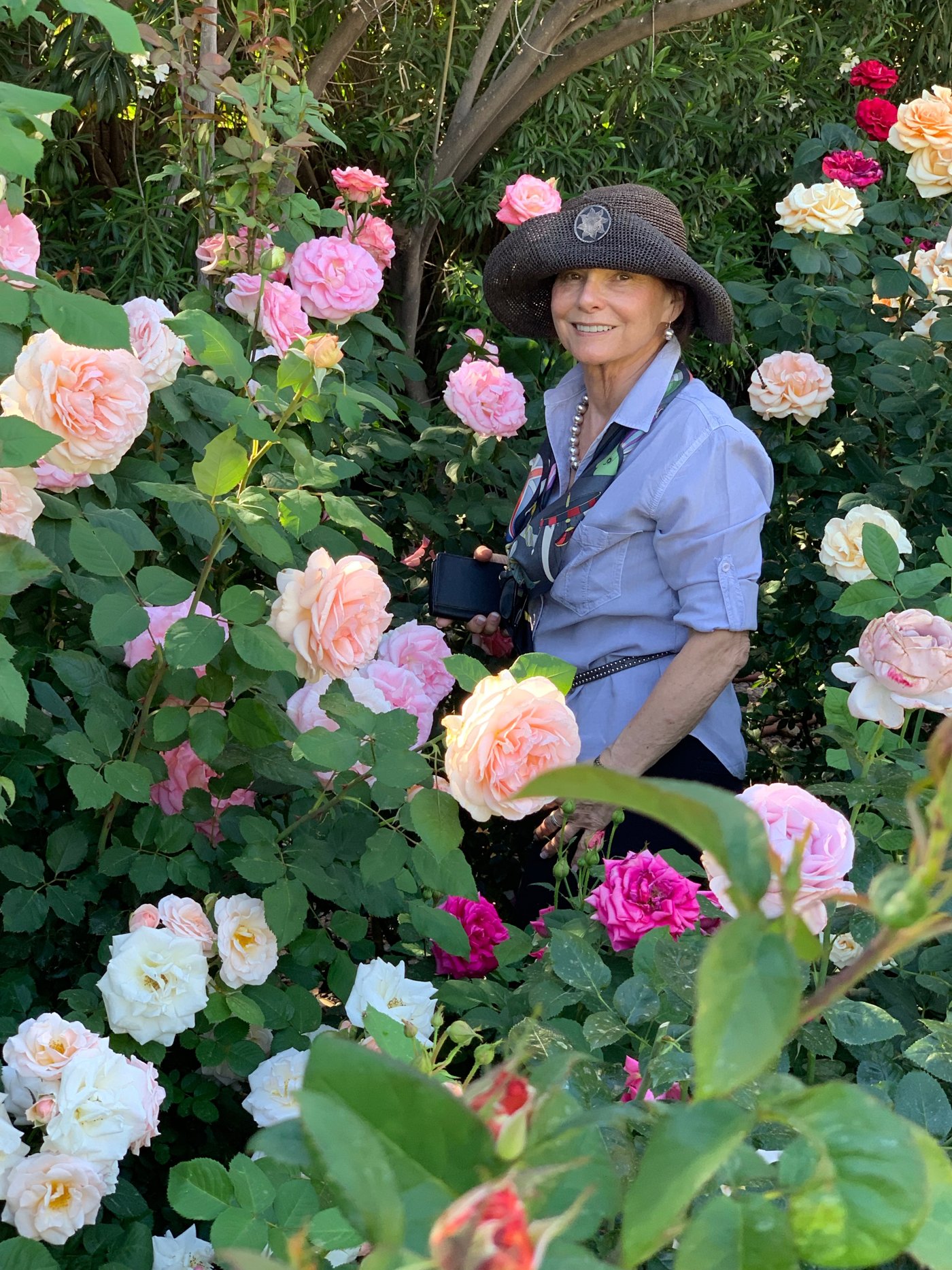 Lorita Winfield among roses in an Arizona garden